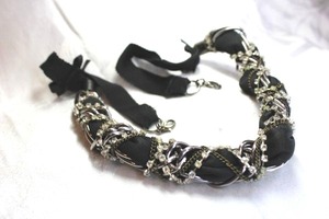 lot 519 image: Black fabric metal link and rhinestone threaded necklace with fabric yoke with bowties and double lobster clasps. 22L