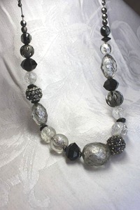 lot 524 image: Signed NY black, silver and clear crackle and hair stone style acrylic bead necklace with metal chain yoke. Has NY hang tag. Lobster clasp. 20L with 3 extender.