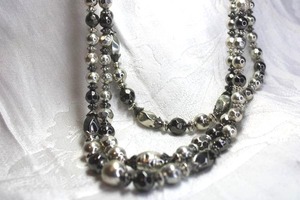 lot 529 image: Signed You & I (New York, 2004-2014) multi strand mixed color black and silver metal ball bead necklace. Lobster clasp. 18L with 3 extender.