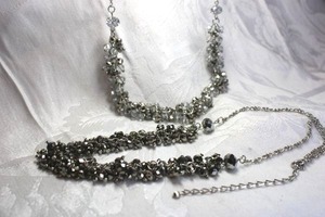 lot 533 image: (2) Faceted clear and smokey glass classic sparkle statement necklaces on matching silver finish chains. Both 18L with 3 extender. Lobster clasps.