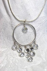 lot 534 image: Signed faceted crystal drop pendant necklace with snake chain. 16L with 3 extender. Has unknown hang tag. Lobster clasp.