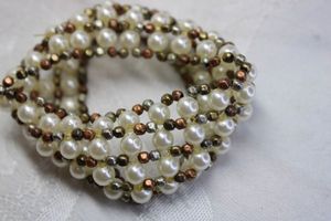 lot 537 image: Gold and silver bi color bead and faux pearl wide stretch bracelet. 1.5W