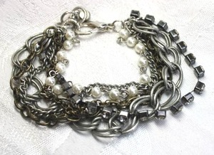 lot 539 image: Mixed metal chain, rhinestone and faux pearl multi strand bracelet with oversized lobster clasp. Adjustable 8-9L