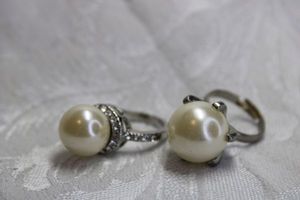 lot 541 image: (2) Pearl jewelry. Includes (2) silver finish large faux pearl rings. Size 6.5 and 6.5 adjustable.