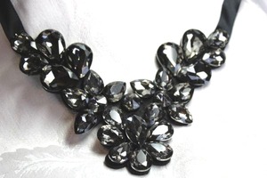 lot 545 image: Faceted large pear shape bib style necklace on fabric backing with ribbon ties. Adjustable up to 38L