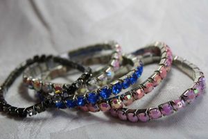lot 558 image: (5) Silver finish rhinestone stretch bracelets