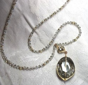 lot 559 image: Elegant and long faceted AB rhinestone necklace with gold wire wrapped smoky faceted crystal pendant. 32L with 3 extender. Drop 3L