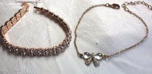 lot 560 image: (2) Rose gold finish bracelets. 7L with fold over clasp and bow bracelet adjustable from 7.5-10L