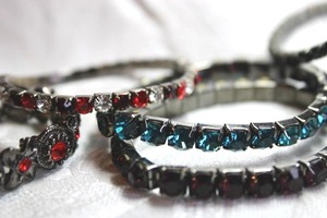 lot 561 image: (6) Dark finish rhinestone bracelets. (1) fixed and (5) stretch bracelets.