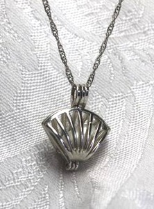 lot 573 image: 18K white gold plated necklace with caged pearl pendant in fan shape. Has 18K GP hang tag. 16L. Spring ring clasp.