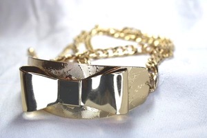 lot 576 image: Gold finish multi chain bracelet with figural bow top. Adjustable 8.5-10.5L Bow is 3L x 1.25W
