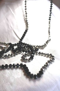 lot 577 image: Classic and timeless faceted glass black and silver continuous necklace. 62L