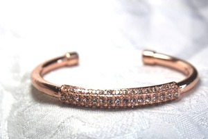lot 581 image: Rose gold finish open cuff bracelet with rhinestone decorated top.