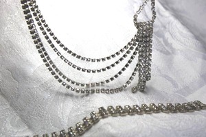 lot 584 image: Art Deco style vintage rhinestone off center necklace and bracelet. 16L with shepherd crook clasp. Bracelet 7L