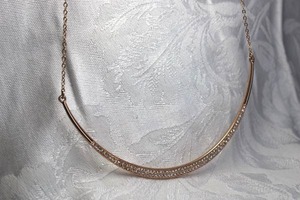 lot 433 image: Signed Chloe  Isabel gold plated half moon pave rhinestone classic chokernecklace. Has C  I hang tag. 14L with 3 extender