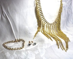 lot 485 image: Gold fringe bib style necklace with rhinestone trim. 14L with S-hook clasp. Includes poststud gold finish earrings and gold finish tennis bracelet 7L