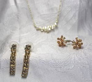 lot 493 image: Gold finish rhinestone jewelry. Includes 16L necklace with 2 extender (lobster clasp) and 2 pairs of rhinestone poststud earrings. Longest is 1.25L