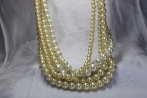 lot 453 image: Classic 4-strand light weight faux pearl necklace with toggle clasp. 18L