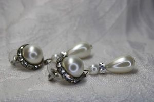 lot 451 image: Classic and timeless faux pearl and rhinestone halo drop poststud drop earrings. 2L