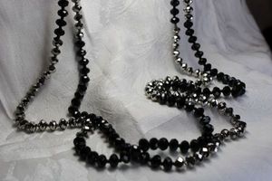 lot 435 image: Faceted silver and black glass bead continuous holiday sparkle necklace. 62L