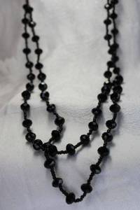 lot 437 image: Faceted timeless and classic black glass continuous necklace. 52L