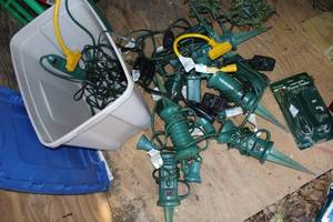 lot 249 image: Tub of Outdoor Powercords, Timers, and Spotlights