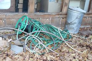 lot 264 image: Large Lot of Hoses, Hose Holders, and Vintage Metal Trash Can