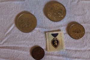 lot 200 image: Purple Heart Forever Stamp and Forgein Coins