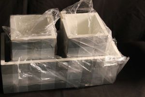 lot 303 image: Grey and white checked planter boxes