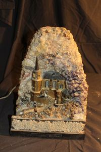 lot 401 image: Vintage from Germany, Crystal and Geode Castle,with Minature bride, groom and priest Needs cleaning and repairs. WILL NOT SHIP BECAUSE OF THE DELICATE NATURE OF IT. BUYER MUST PICK UP