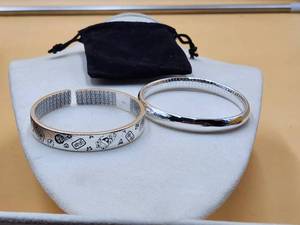 lot 123 image: Jewelry pair of silver bracelets marked .999