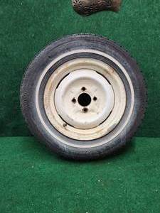 lot 438 image: Rim and tire - believed to be from a 1950s MG