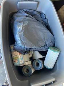 lot 289 image: Bin of small pool filters and pump with pool liner-cover