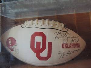 lot 90 image: OKLAHOMA OU Football in wooden box signed BY 1978 HEISMAN WINNER BILLY SIMS JOHNNY  in case
