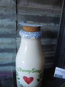 lot 63 image: a penny saved a penny earned coin bank  change inside unknown