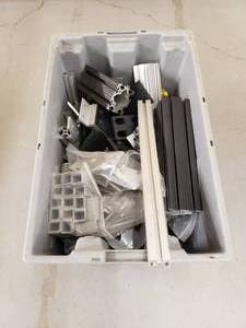 lot 209 image: Tub Full of Misc Extruded Aluminum Pieces.  Tub is Included.