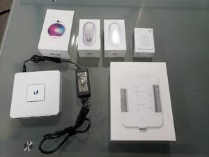 lot 554 image: Lot of Ubiquiti UniFi Items.  Includes UA Hub, Security Gateway, Ethernet Surge Protector, Access Reader Lite (Qty 2) & Reader Pro