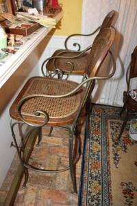 lot 84 image: Cane back Bar height chairs with heavy iron frame