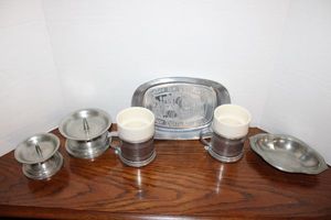 lot 103 image: Pewter candle holders, Armatale coffeetea mugs, and trays as shown