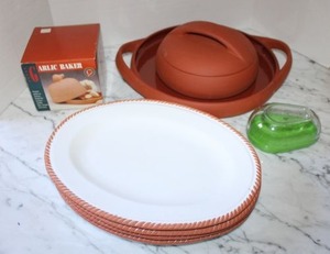 lot 119 image: Bortner & Bortner Terra Cotta Tortilla Warmer and tray, ceramic plates, Garlic baker, and avocado saver