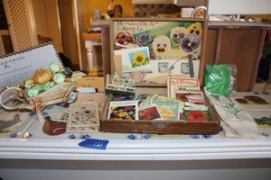 lot 121 image: Seed collection with Mandeville & King Co. box, garden gloves, ceramic veggie teapot