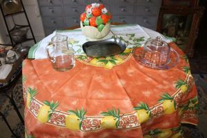 lot 123 image: Ceramic orange basket, lemon and lime table linens, glass pitcher and serving plate with lid