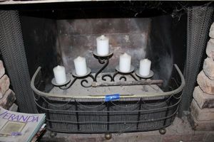 lot 395 image: Fireplace screen and iron candle holder