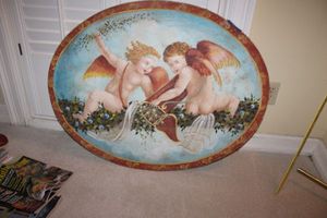 lot 291 image: Wall art - cherub oval painting - 28x36