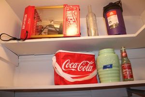 lot 337 image: Vintage Coca-Cola jade glass cookie jar(missing lid), Popcorn maker, coolers and collector bottles