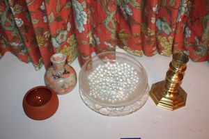 lot 257 image: Glass bowl with marbles, brass candle holder, glazed vase, and terra cotta bowl with ladle