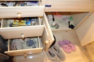 lot 481 image: Bathroom rug, slippers, and drawer contents