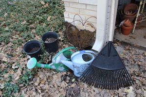 lot 587 image: Garden Watering cans, rake, metal heart trellis and more