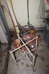 lot 559 image: Metal X stand, planters, fireplace log holder, and extension tree trimmer