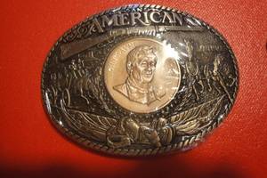 lot 10 image: An American John Wayne Belt Buckle by Rainy Mountain Design, 3 12x 2 12, First Edition No. 9914, Sealed in Original Plastic